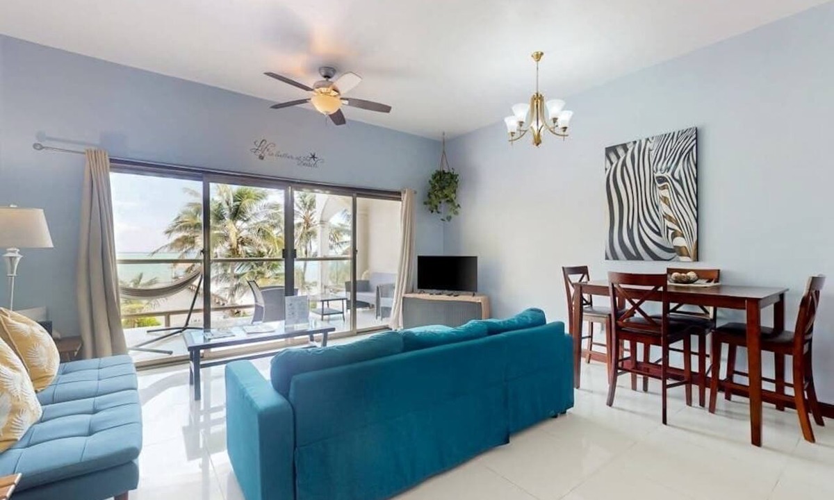 San Pedro Condo | Beachfront condo with balcony, sea view, partial AC, pool, dock & kayaks