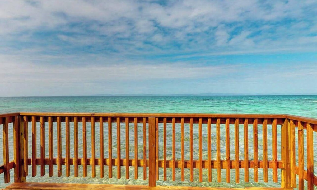 Sittee Point Apartment | Overwater cabin with oceanfront deck, island kitchen & sea breeze views