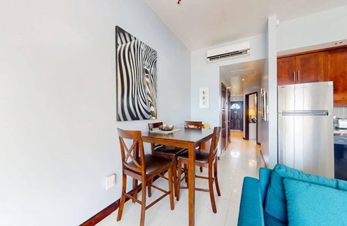 San Pedro Condo | Beachfront condo with balcony, sea view, partial AC, pool, dock & kayaks