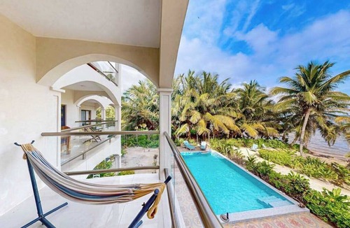 San Pedro Condo | Beachfront condo with balcony, sea view, partial AC, pool, dock & kayaks