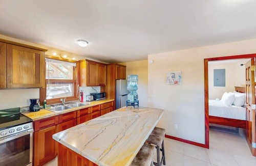 Caye Caulker House | Dazzling beach stay with a balcony - pool, bikes, canoes, grill, & dock access