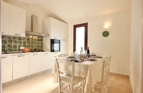 Sant'Elmo Villa | Delightful air-conditioned villa of approximately 135 m2 composed of a living room with sofas and satellite TV, kitchenette with gas stove, fridge, oven, dishwasher and microwave.Washing machine outside with clothesline.Two double bedrooms and a bedroom