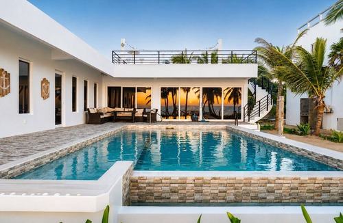 San Pedro House | Luxury beachfront vacation rental on Ambergris Caye with a private pool, rooftop lounge, private casita, direct beach access, and full-service concierge. Perfect for families, couples, and group getaways in Belize.