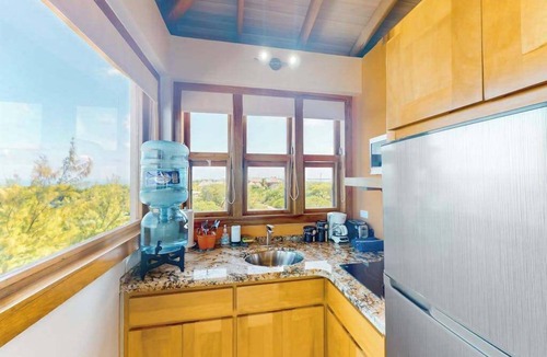 Caye Caulker Apartment | Panoramic loft with beach, pool, canoe, dock, & grill access - scenic balcony