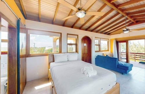 Caye Caulker Apartment | Panoramic loft with beach, pool, canoe, dock, & grill access - scenic balcony