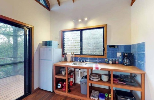Surfside Cabin | Quiet treehouse cabana with veranda, hammock, WiFi & partial AC - walk to beach