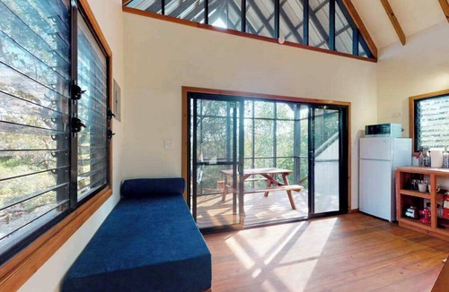 Surfside Cabin | Quiet treehouse cabana with veranda, hammock, WiFi & partial AC - walk to beach
