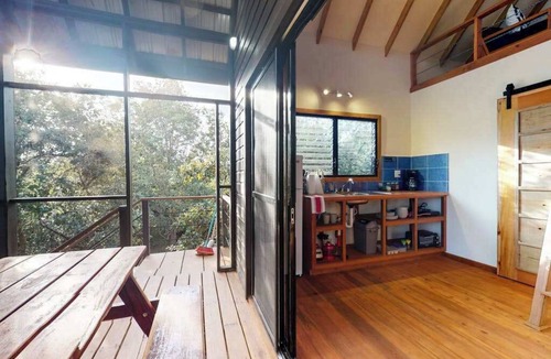 Surfside Cabin | Quiet treehouse cabana with veranda, hammock, WiFi & partial AC - walk to beach