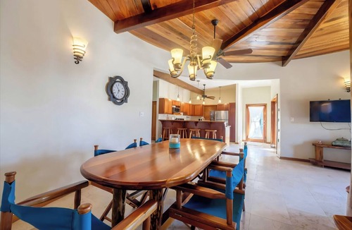 Gales Point Condo | Welcome in the island breeze or head outside to sit on the large deck,
