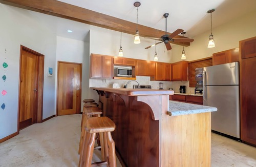 Gales Point Condo | Welcome in the island breeze or head outside to sit on the large deck,