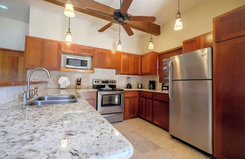 Gales Point Condo | Welcome in the island breeze or head outside to sit on the large deck,