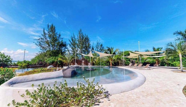 Beachfront retreat with pool, private hot tub, AC, & lagoon view