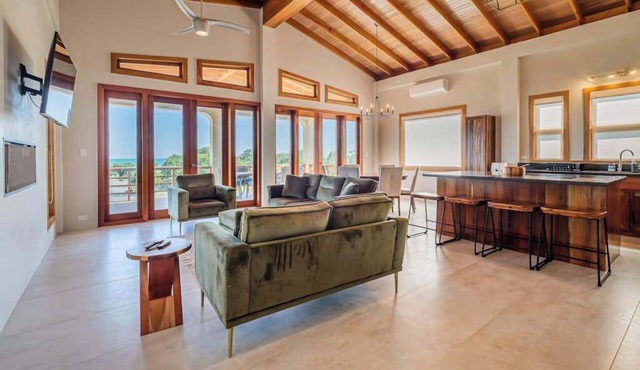 Tropical retreat villa with a pool, dock, bikes, canoes, balconies, and 360 views